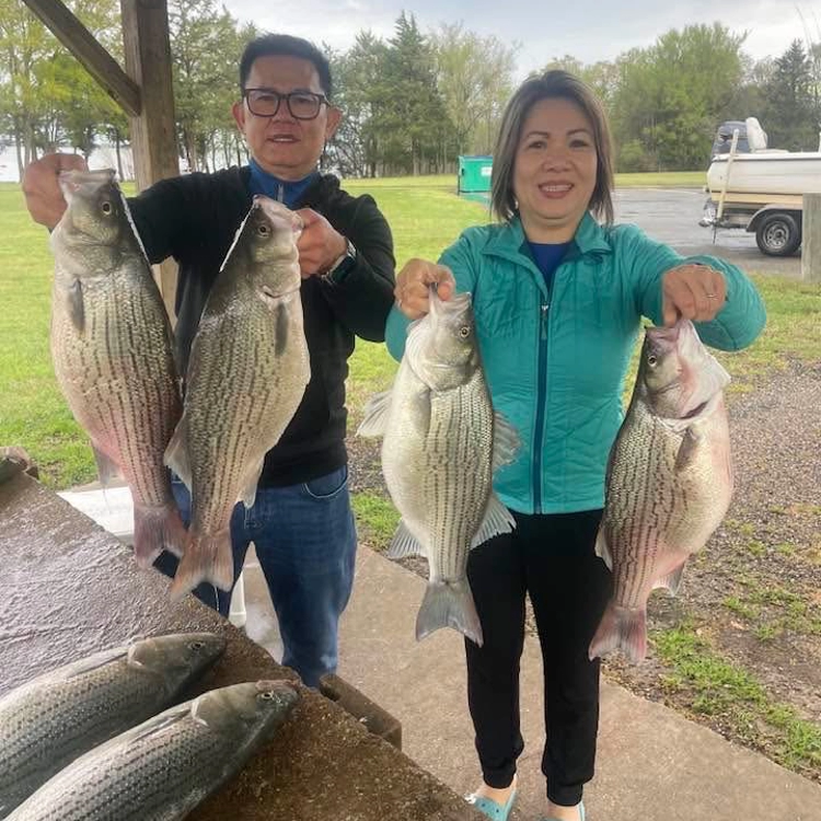Lake-Tawakoni-Fishing-Charter-1A Lake Tawakoni fishing charter clients holding striped bass catch with guide trip success